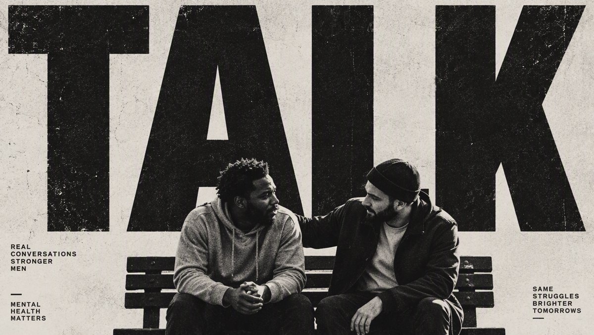 Two men sitting on a park bench in honest conversation, one listening with genuine care β men's mental health support and connection