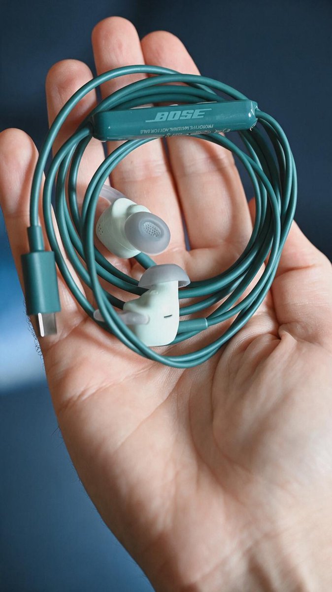 The coiled cable, inline remote, and a USB-C plug physically attached to the earbuds