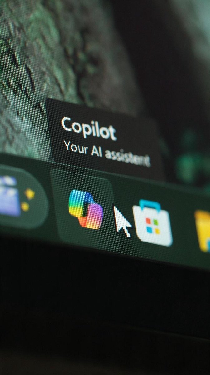Macro close-up of a Windows taskbar with the cursor hovering over the Copilot icon