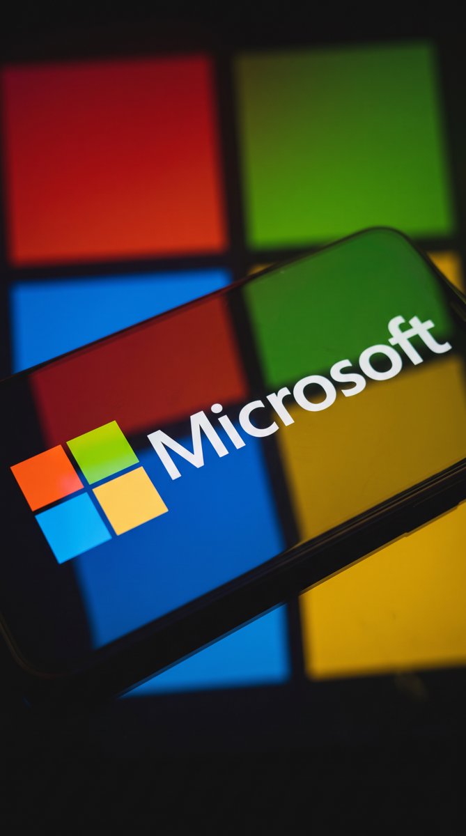 Microsoft logo and four-color tiles glowing on a screen