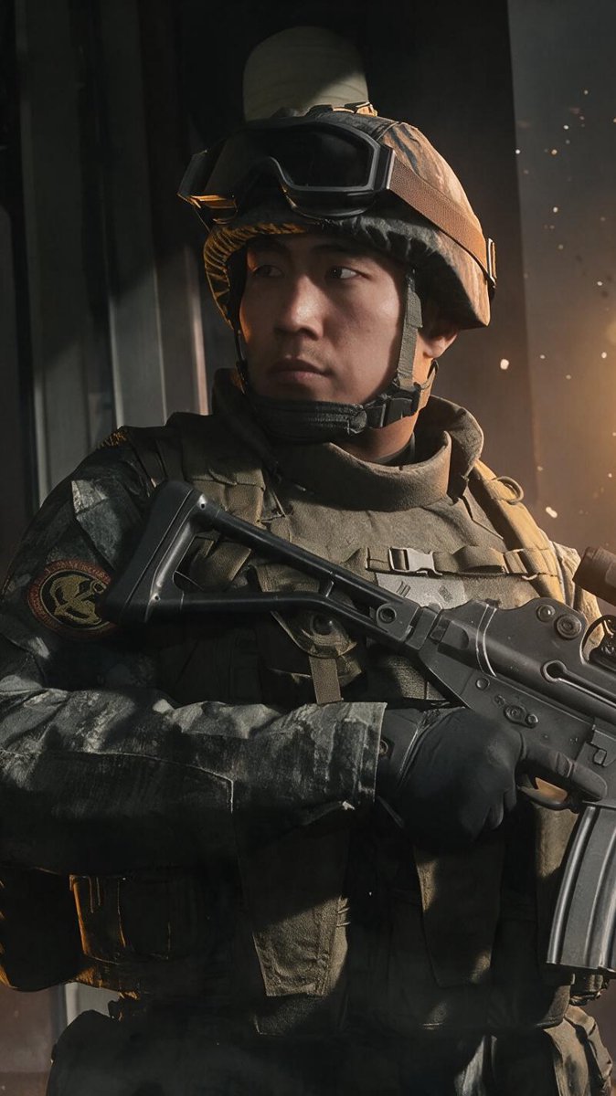 Soldier in combat gear holding a rifle in front of a burning building at night — Modern Warfare 4's opening invasion of Seoul