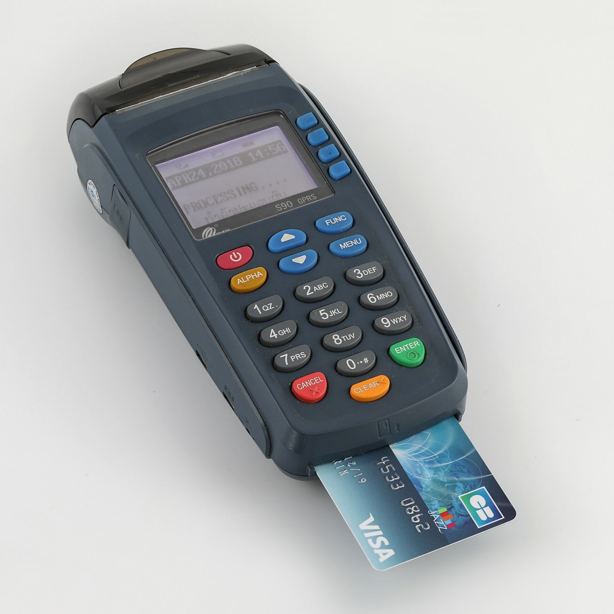 Real close-up photograph of a Visa bank card inserted into a payment terminal